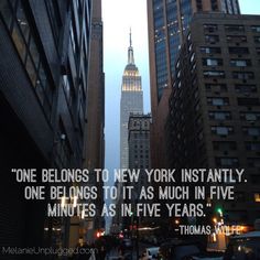 a city street with tall buildings and a quote from thomas adams about new york's skyscrapers