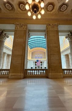 the inside of a building with columns and lights