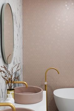 a bathroom with two sinks and a large mirror on the wall next to each other