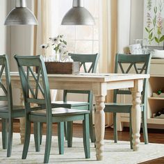 a dining room table with four chairs around it