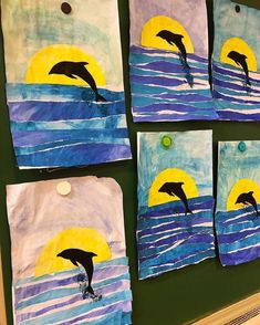 four pieces of paper with dolphins jumping out of the water in front of a yellow sun