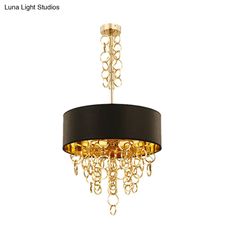 a black and gold chandelier with chains hanging from it's center piece