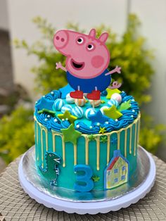 a peppa pig birthday cake sitting on top of a table