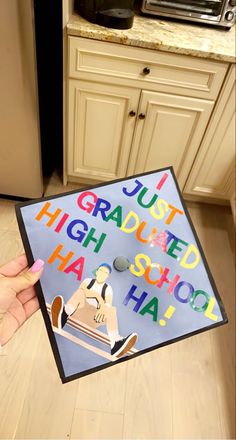 someone holding up a sign that says just graduated high school haha in front of a microwave