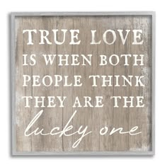 a wooden sign that says true love is when both people think they are the lucky one