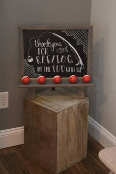 a chalkboard sign on top of a wooden box