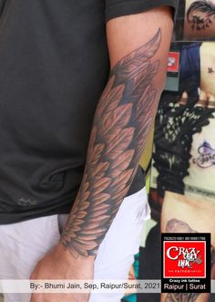 a man's arm with an eagle tattoo on it