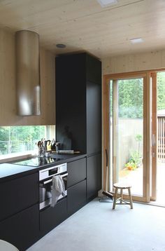 a kitchen with black cabinets and an oven