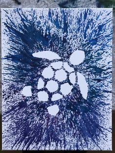 a blue and white painting on a piece of paper