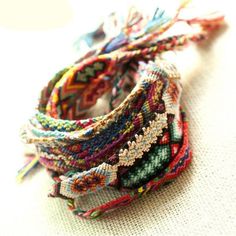 multicolored bracelets are stacked on top of each other