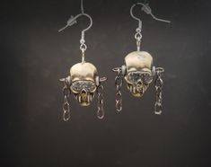 "This is a pair of earrings designed after Megadeth's iconic skull mascot, Vic Rattlehead. ( I did'nt know that was his name until recently).  They were sculpted, cast in resin, and painted by hand and set with chains  hanging from the sides.  The top eyelets are screwed in so they can be turned to position.  Skull is  5/8\" W x 1\"H x 3/4\"D, note the third pic for size reference." Edgy Nickel-free Skull Earrings, Handmade Alternative Style Earrings For Gift, Handmade Metal Skull Earrings, Nickel-free Skull Earrings In Punk Style, Skull Shaped Metal Earrings, Max Core, Vic Rattlehead, Wire Wrap Jewelry Designs, Slipknot