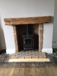 an old brick fireplace with a wood burning stove