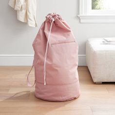 a pink bag sitting on top of a wooden floor