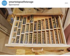 a wooden box filled with lots of screws