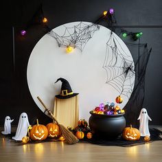 halloween decorations with pumpkins and jack - o'- lanterns in front of a white circle