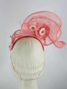 This women's peach/coral fascinator hat is a sure bet for Kentucky Derby or Kentucky Oaks. Or any summer event really, like church, ladies tea, or just for fun. It is made with sinamay straw and is very light and airy. The hand sculpted sinamay sits atop a handmade bandeau base and is secured with an elastic band that goes behind the ears and head to keep the hat in place. It is topped with vintage daisies and hand rolled sinamay leaves as well as sinamay swirls for added texture. An inner grosg Kentucky Oaks, Ladies Tea, Custom Made Hats, Sinamay Fascinator, Ribbon Headbands, Large Hats, Fascinator Hat, Fascinator Hats, Summer Events