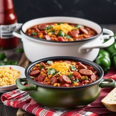 two bowls filled with chili and corn on top of a table