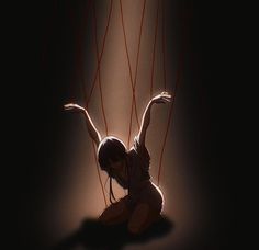 a woman sitting on the ground with her hands in the air and strings attached to her body