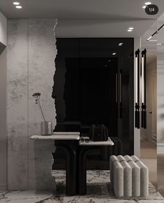 a black and white dining room with marble table, chairs and vases on the floor