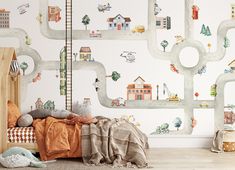 a child's bedroom with a map wallpaper and toy cars on the walls