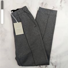 Tailored Look, Sweatpant Feel. Made Of Soft Double-Knit Fabric, The Dream Pant Features An Elastic Waist, Pintuck Detailing, And A Sleek Tapered Leg. Plus, It Has A Flat Finish, So It Looks Polished, But It’s Comfortable Enough To Nap In. The Best Part? It’s Wrinkle Resistant. From Morning Meetings To Afternoon Errands To Late-Night Loungingthis Pant Looks (And Feels) Like A Dream. New With Tags Drawstrings Inside Waistband Waist 13.5” Across Inseam 28” Rise 10” Fitted Gray Sweatpants For Winter, Fitted Everlane Bottoms For Workwear, Everlane Fitted Pants For Workwear, Chic Fitted Sweatpants With Pockets, Fitted Straight Sweatpants For Winter, Morning Meetings, Morning Meeting, Double Knit, Pin Tucks