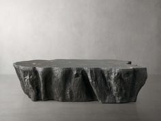 a table made out of rock with an artistic design on it's top and bottom