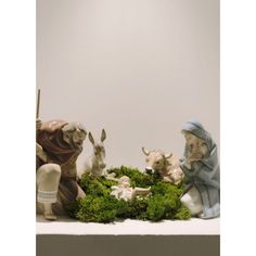 the nativity scene includes figurines of animals and people