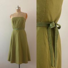 A fabulous green day dress by Ann Taylor from the early 2000s. It zips up the center and has a structured, secure lining. The included green waist belt ties into a decorative bow, completing the look. era: y2K  tag size: 8 meausrements: bust 36" waist 31" hips - up to 45" total length 35.5" brand: Ann Taylor condition: good vintage condition Fitted Green A-line Strapless Dress, Green Fitted Strapless Cocktail Dress, Elegant Fitted Green Strapless Dress, Elegant Green Fitted Strapless Dress, Green Fitted Strapless Dress, Green Fitted Strapless Mini Dress, Green Strapless Dress With Fitted Bodice, Green Fitted Strapless Midi Dress, Green Strapless Dress For Spring