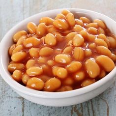 a white bowl filled with beans on top of a table