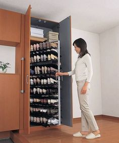 a woman standing in front of an open cabinet