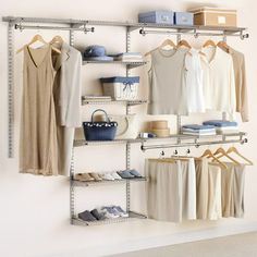 an organized closet with clothes and shoes hanging on the wall, along with other items