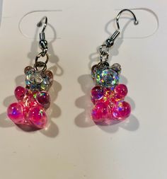 These gummy bear charm earrings are incredibly lightweight and perfect for the most sensitive of ears. These earrings are perfect for any event or day. They are fun, colorful, and glittery making them stand out in an adorable way. The charm is small so they are not overwhelming and add just a touch of color to any outfit! These earrings will make an absolutely perfect birthday or holiday gift Beaded Animals, Gummy Bears, Etsy Earrings Dangle, Charm Earrings, Holiday Gifts, Jewelry Earrings Dangle, Dangle Drop Earrings, Candy, Dangle Earrings