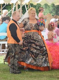 a couple of people that are standing in the grass