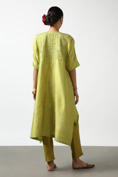 Olive green asymmetric kurta with floral mirror embroidery and side slits. Paired with pant.
Components: 2
Pattern: Embroidered
Type Of Work: Mirror
Neckline: Round
Sleeve Type: Half
Fabric: Raw silk
Color: Green
Other Details: 
Side slits
Zipper detailing
Disclaimer: While the designer strives to recreate every piece as close to what is displayed on the website, there may be subtle variations in color and design. If you have any concerns about the textile, kindly contact the customer service
Oc Spring Anarkali Set With Mirror Work And Straight Kurta, Festive Green Pant Set With Resham Embroidery, Spring Chanderi Anarkali Set With Mirror Work, Spring Salwar Kameez With Mirror Work And Traditional Drape, Traditional Spring Salwar Kameez With Mirror Work, Designer Green Pant Set With Zari Work, Traditional Green Pant Set With Resham Embroidery, Traditional Drape Salwar Kameez With Mirror Work For Spring, Spring Pista Green Kurta With Mirror Work