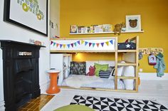 there is a bunk bed in the corner of this room with yellow walls and white flooring