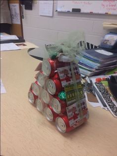 a stack of cans sitting on top of a wooden table