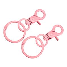 two pink plastic handcuffs are shown on a white background with clippings for each one