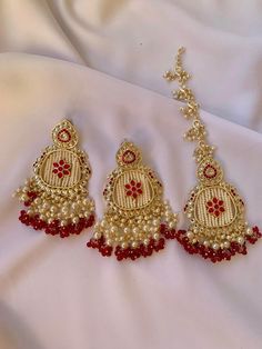 Step into a world of elegance and tradition with our exquisite Floral Design Kundan Stones Chaand Bali Earrings and Tikka Set. Each piece is adorned with vibrant colored pearls and delicately encased in lustrous gold-plating, making it a perfect fit for both bridal and party occasions. Inspired by the rich cultural heritage of Indian, Pakistani, and Desi aesthetics, this jewelry set promises to elevate your style. Available in three captivating colors - red, pink, and turquoise - choose the shade that resonates with your personality and occasion. Order now and make a statement that echoes timeless beauty and sophistication with this stunning set. Desi Jewelry, Colored Pearls, Desi Aesthetics, Bali Earrings, Jewelry Bridal, Wedding Jewelry Earrings, Cultural Heritage, Pearl Color, Design Floral