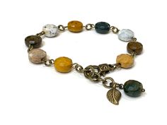 Dive into the serene beauty of the ocean with our Ocean Jasper Gemstone Bracelet, meticulously crafted with 10mm natural Ocean Jasper faceted round stones. Each bead showcases the unique and captivating patterns that Ocean Jasper is known for, offering a glimpse of the ocean's calm and grounding energy. This bracelet is elegantly accented with antique bronze-color brass, adding a touch of vintage charm. The design includes a secure lobster-claw lock and an extender chain, providing easy adjustme Adjustable Nature-inspired Jewelry With Round Beads, Adjustable Nature-inspired Jewelry With Gemstone Beads, Nature-inspired Adjustable Jewelry With Gemstone Beads, Nature-inspired Agate Beaded Jewelry, Nature-inspired Agate Bead Jewelry, Adjustable Faceted Agate Jewelry, Earthy 8mm Bead Bracelet, Earthy 8mm Beads Bracelet, Artisan Jewelry With Ocean Jasper Gemstone Beads