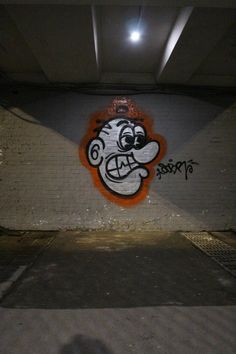 graffiti on the side of a wall in a parking garage