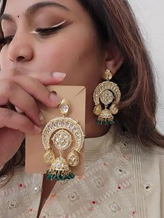 A pair of golden-toned Traditional Floral Hand Painted Yellow Meenakari Jhumka for Women. This Lightweight dome Shaped Meenakari Earrings with Hanging Pearls is very much in high trend gives you a real ethnic as well as antique look. It looks beautiful, is durable & also affordable. This Meenakari Hand Painted Earring is designed for all age groups. Featuring an exquisite design, these meenakari earrings will go well with any Indian outfit. You can match it up with Saree, Lehenga Choli, Salwar S Meenakari Earrings, Saree Lehenga, Hand Painted Earrings, Chandbali Earrings, Painted Earrings, Indian Outfit, Lehenga Choli, Earring Backs, Exquisite Design