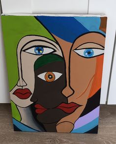 a painting on the wall with two people's faces painted in different colors and shapes