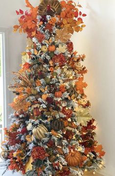 a decorated christmas tree with orange and gold decorations