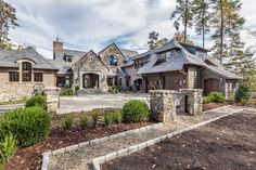 a large house with lots of windows and landscaping