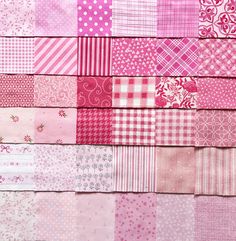 a pile of pink and white patchwork fabric