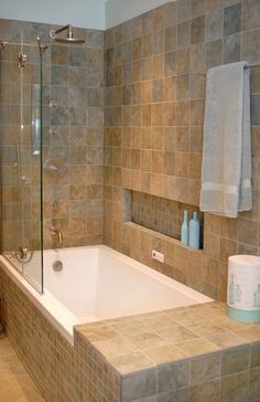 a bath tub sitting next to a walk in shower