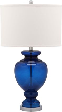 a blue glass table lamp with a white shade on the top and bottom part of it