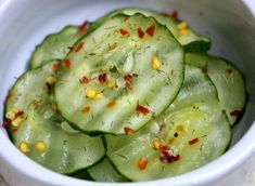 cucumber slices with spices in a white bowl