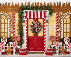 a red door decorated with candy canes and christmas decorations