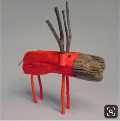 a wooden horse with branches sticking out of it's back